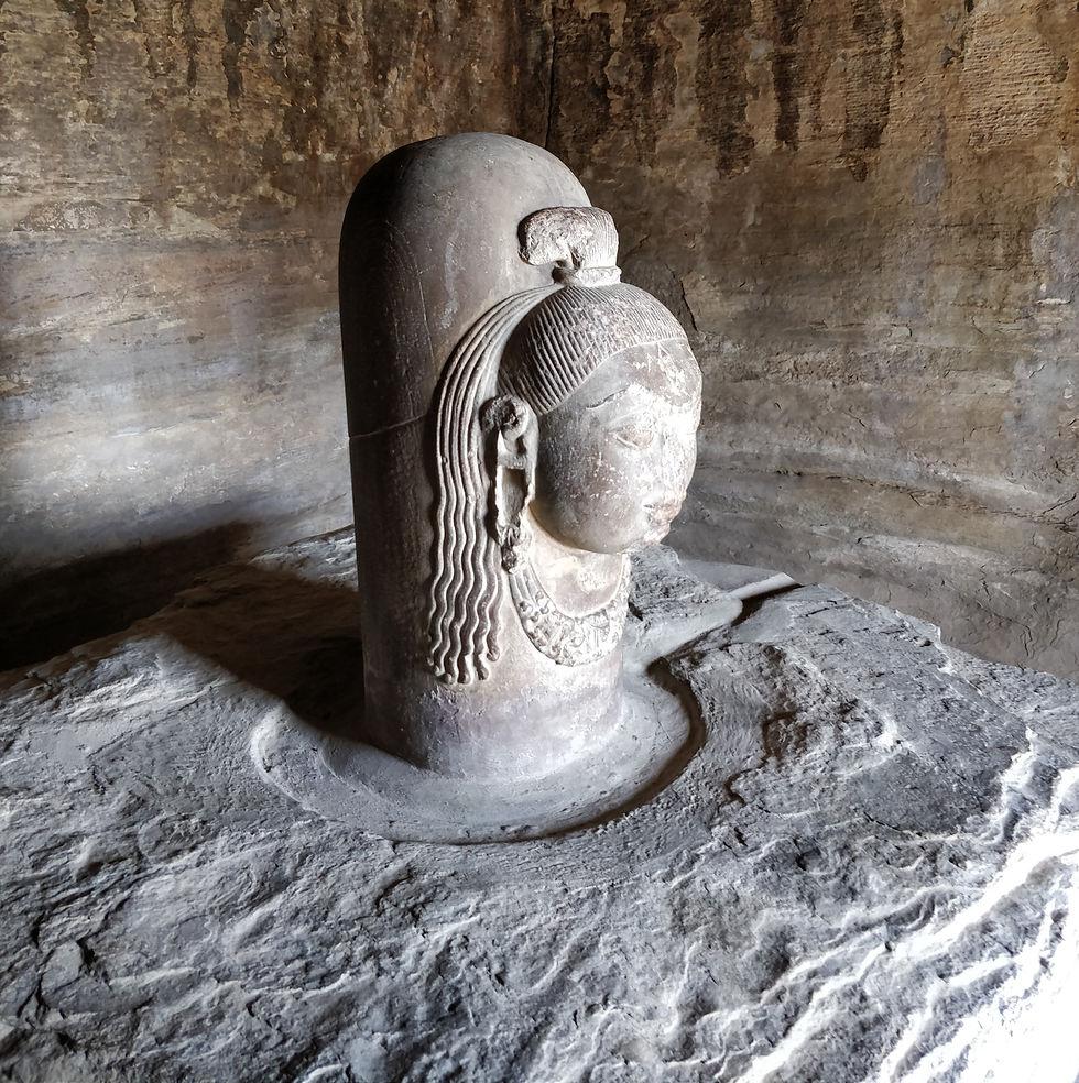Ancient carved Shiva Lingam form in a stone chamber